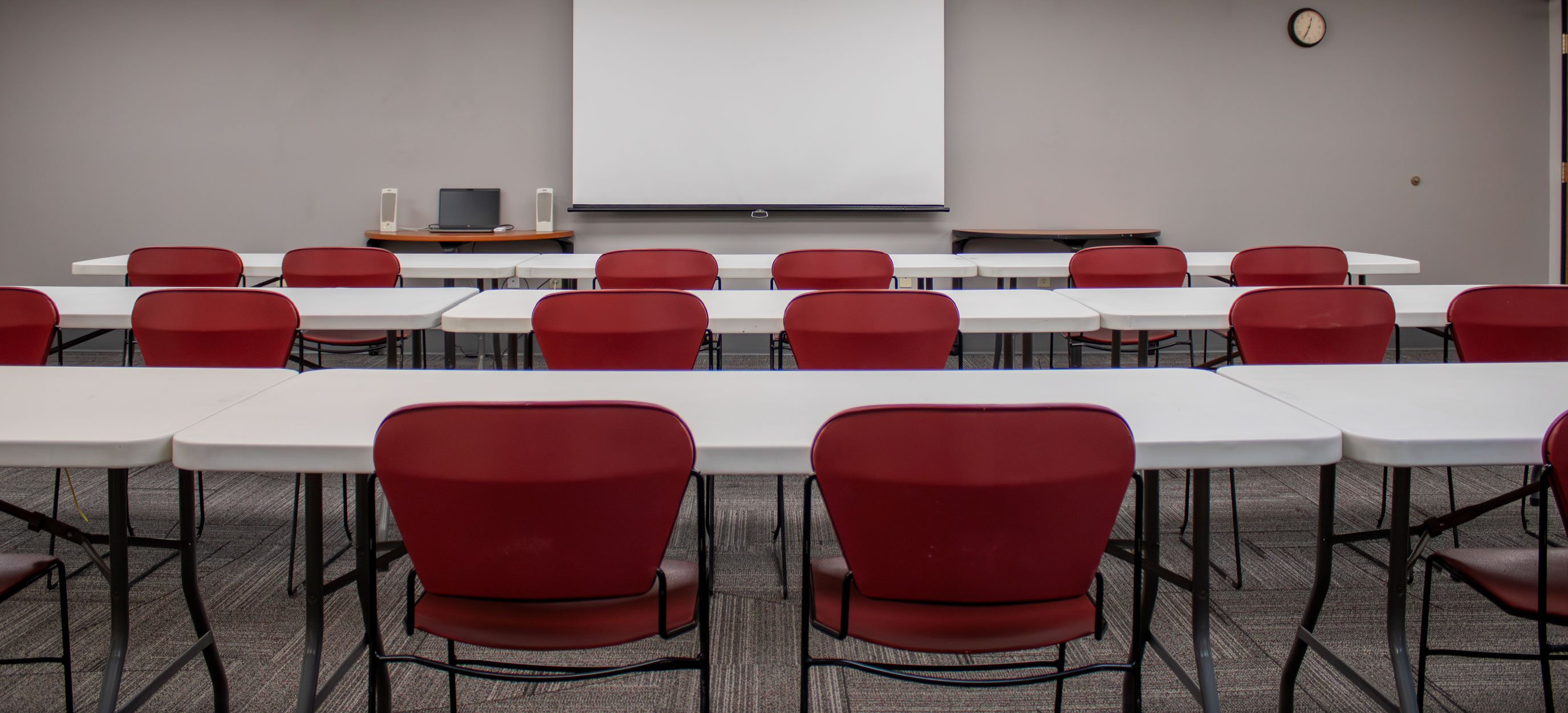 BSUB 108 arranged in a classroom set up facing the front towards a projector screen.