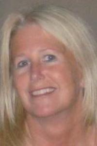 A medium skin toned woman with white-blond hair 