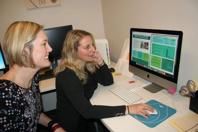 Two professors viewing computer screen