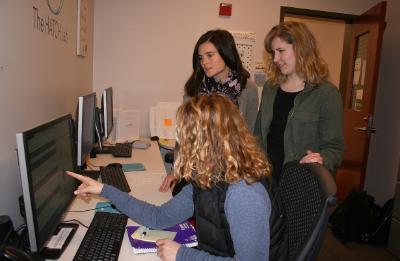 Students sitting and computer