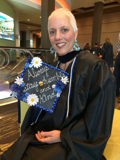 Woman holding graduation cap
