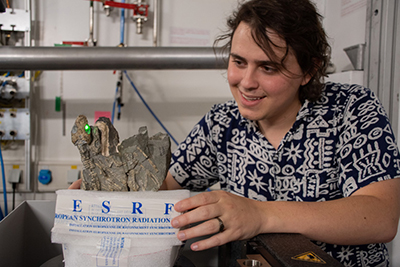 Image of Xavier Jenkins with reptile fossil