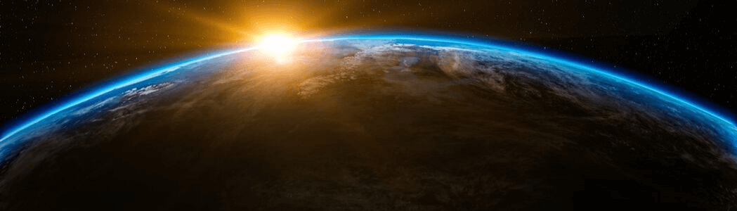 Photo of sun cresting earths horizon from space