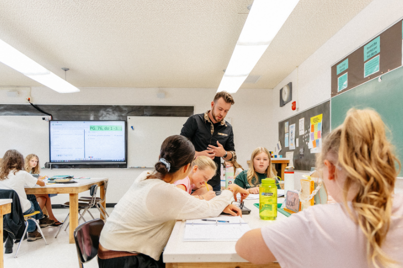 Teacher assisting group of students
