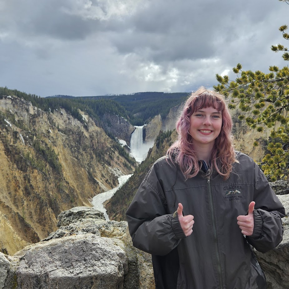 Chloe Lemmon posed in front of Artist Point at Yellowstone National Park