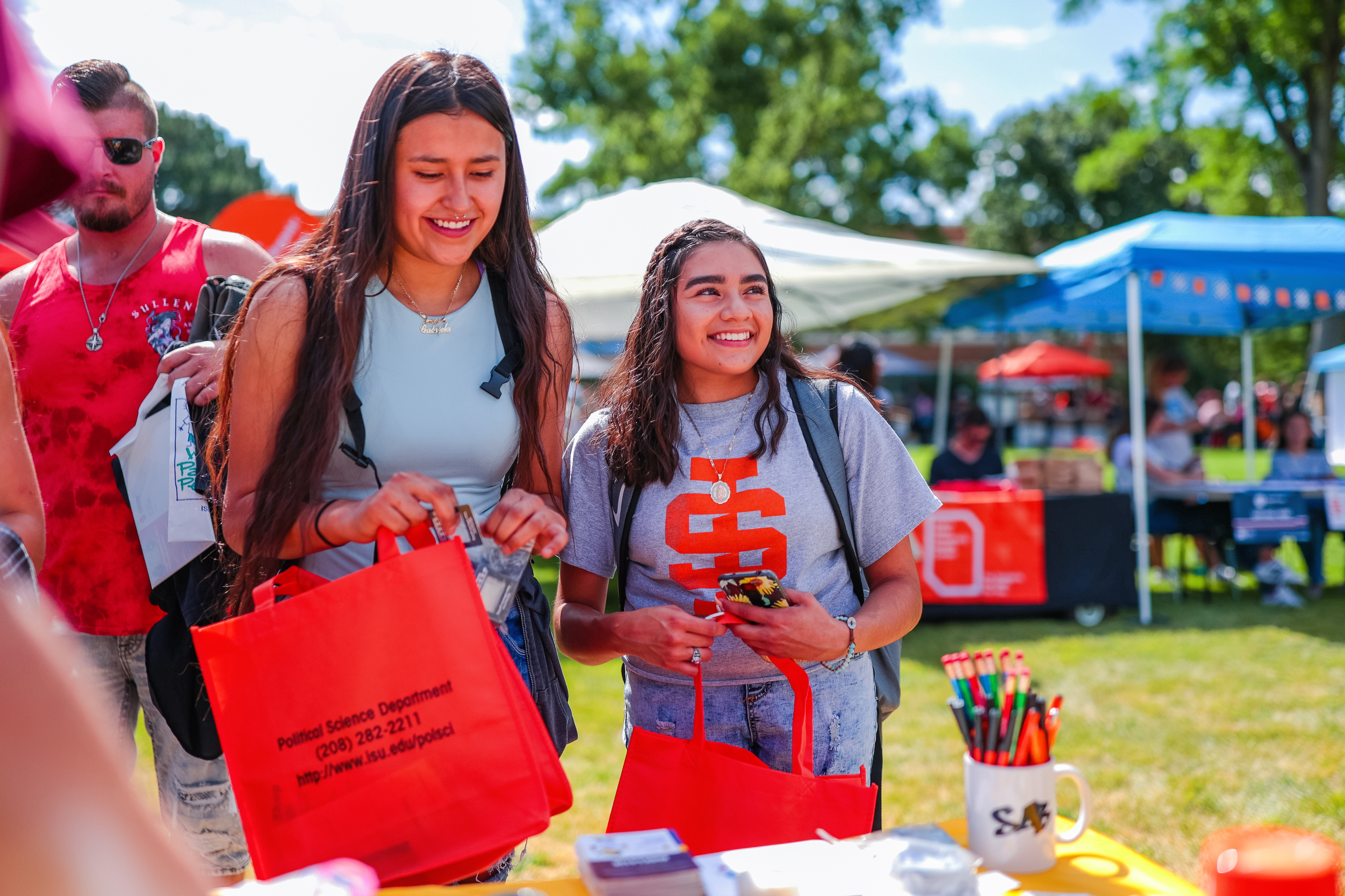 Two students with University-branded items.