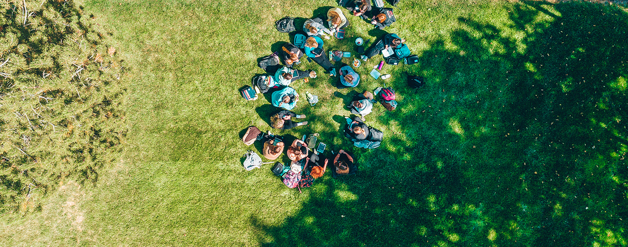 A group of students sitting on the Quad