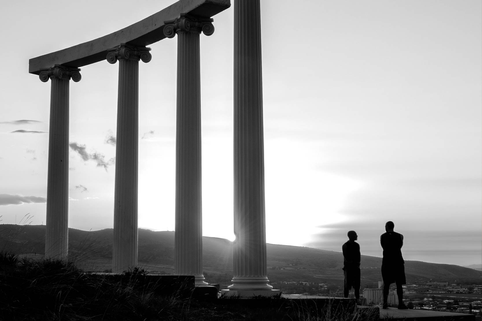 Two people stand close to the ISU pillars.