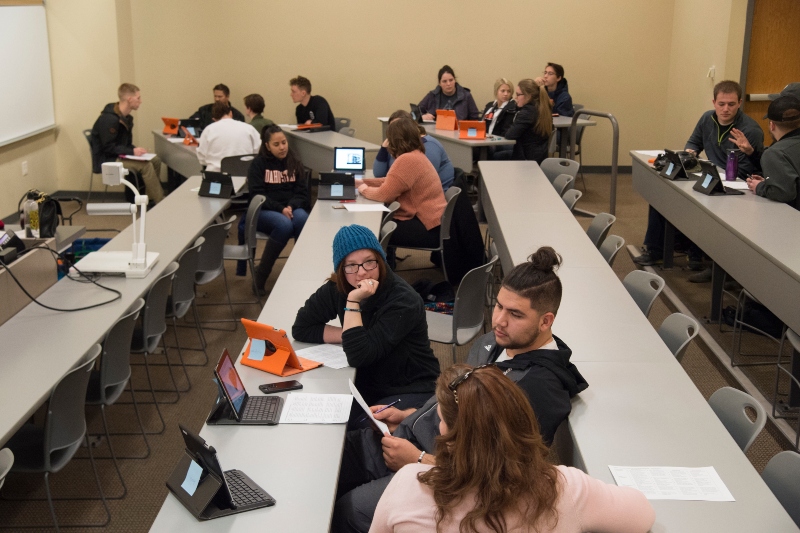 students at tables in a classroom