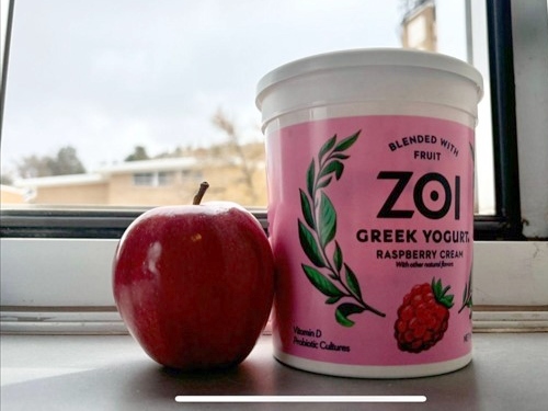 Apple and yogurt by a window.