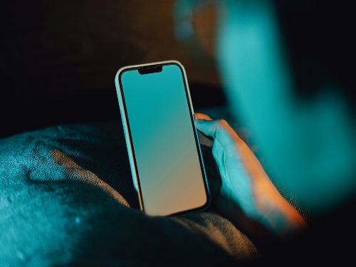 Cell phone being used, blue light emitting.