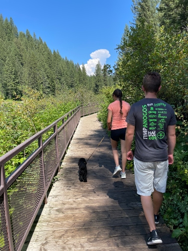 Student walking a dog.