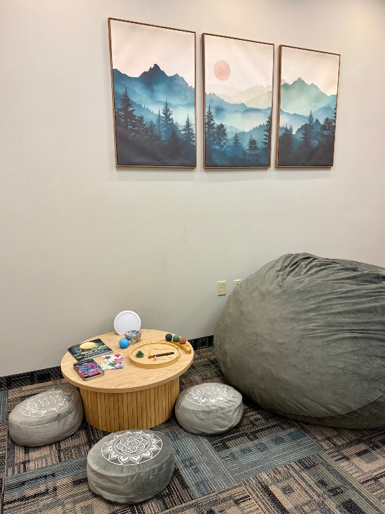 Small table with three cushions, large bean bag.
