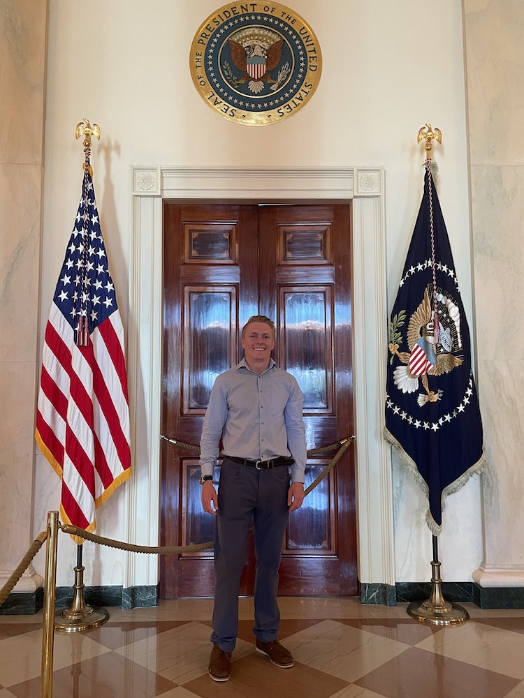 Eric Morris stands between two flags.