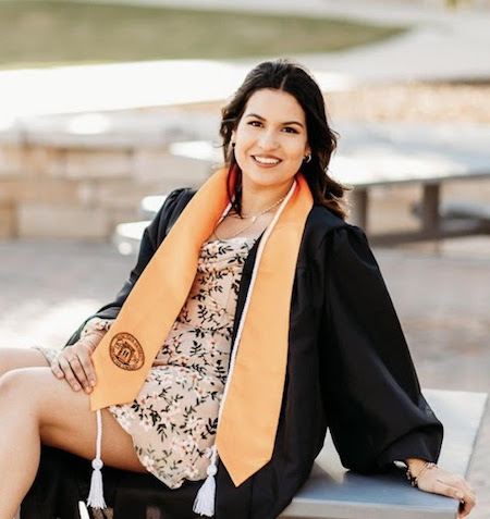 A student plays a piano while another one listens