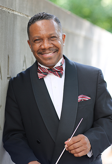 Conductor Raymond Wise poses with his baton