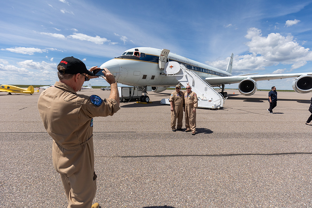 The DC-8 Airplane Flight Crew poses for one last photo with the aircraft.