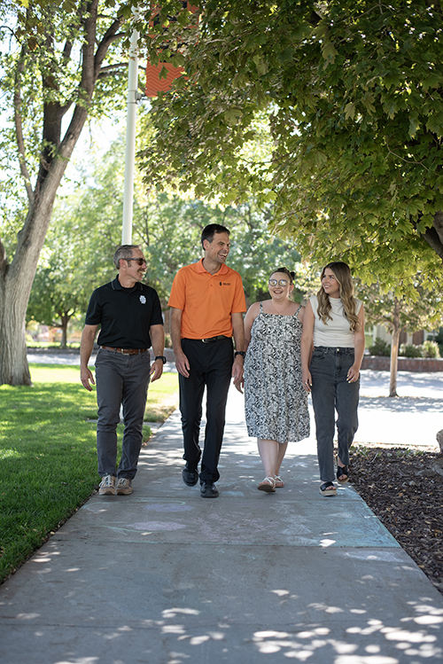 group of students and professor walking on campus