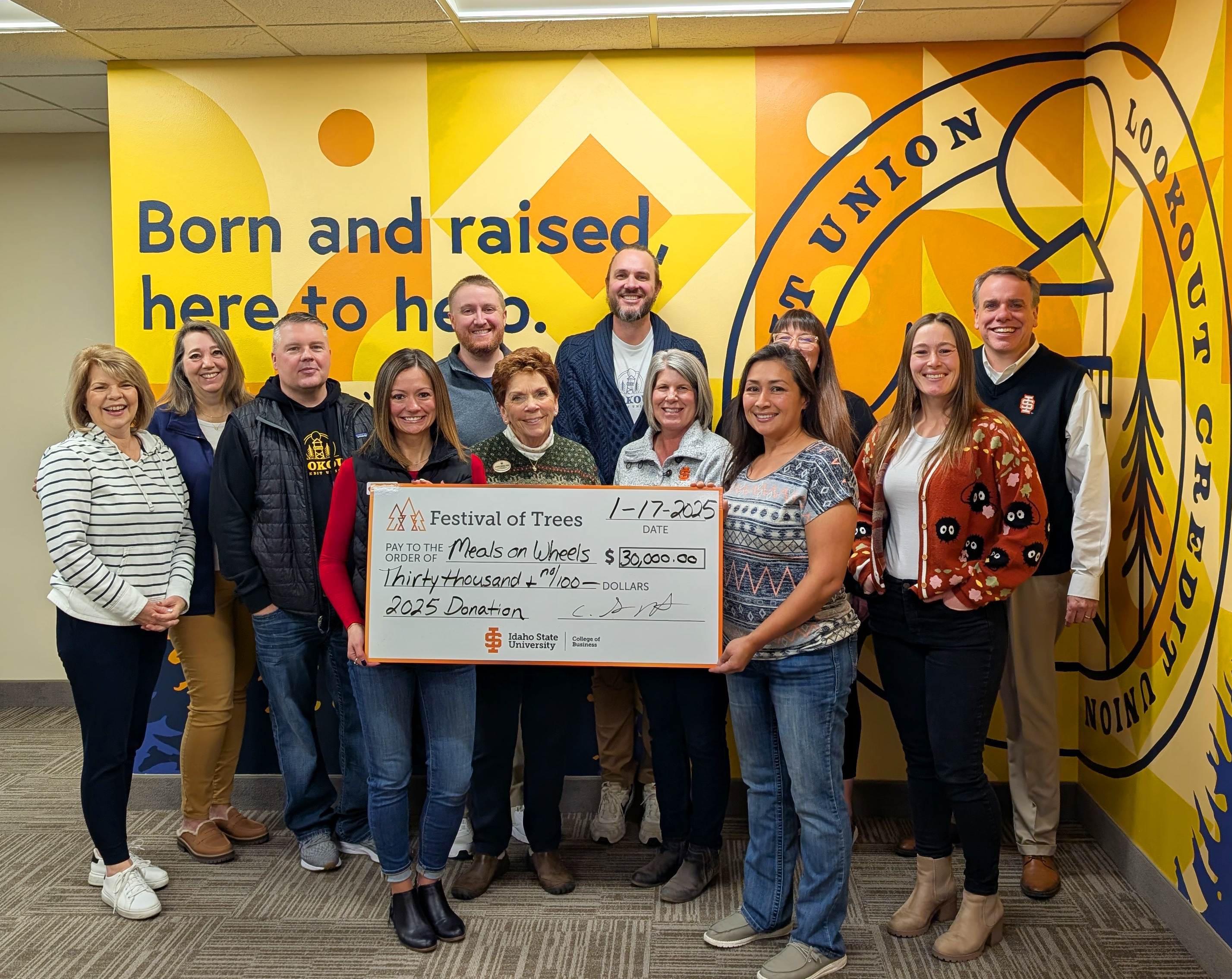 Festival of Trees committee members from the College of Business present a check for $30,000 to local non-profit Meals on Wheels