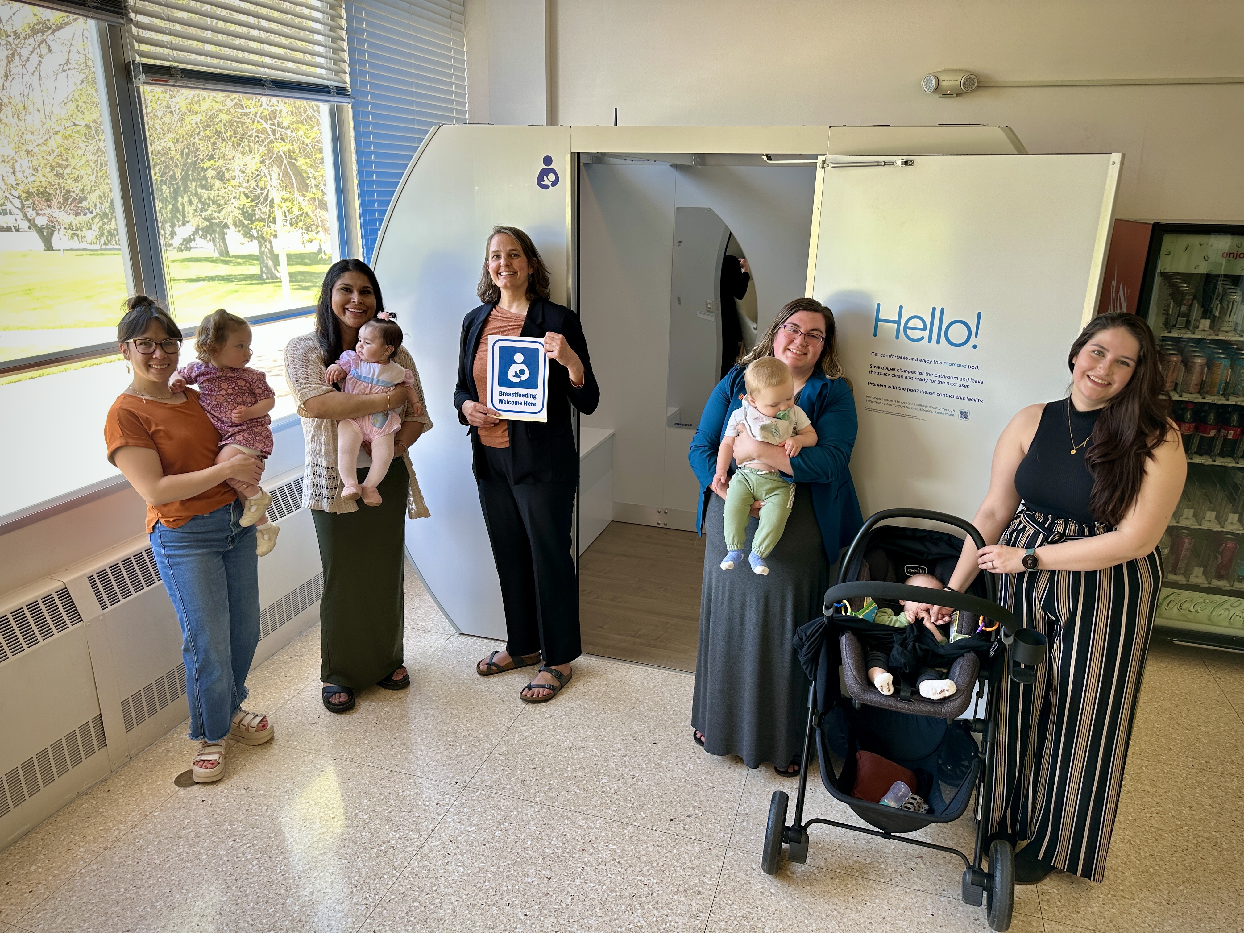 mothers and babies in front of a new lactation pod at ISU