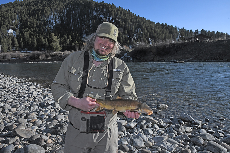 Tyson Hallbert poses for a photo holding a green sucker.