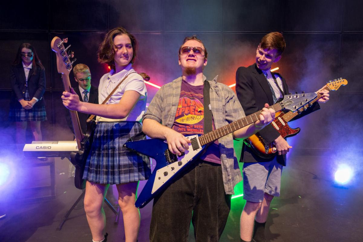 Actors with guitars in School of Rock performance