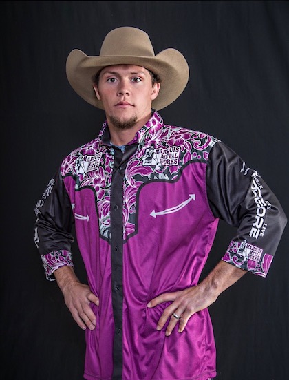 Ryker Fenstermaker with purple cowboy hat and shirt.