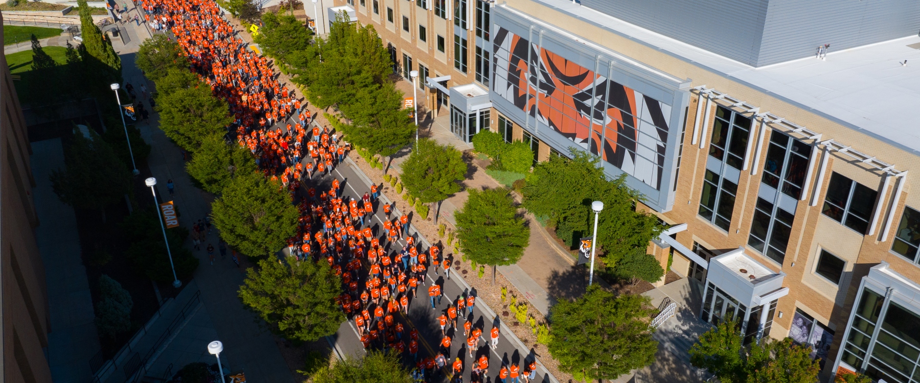 Student walking past the Rendezvous Center during New student convocation