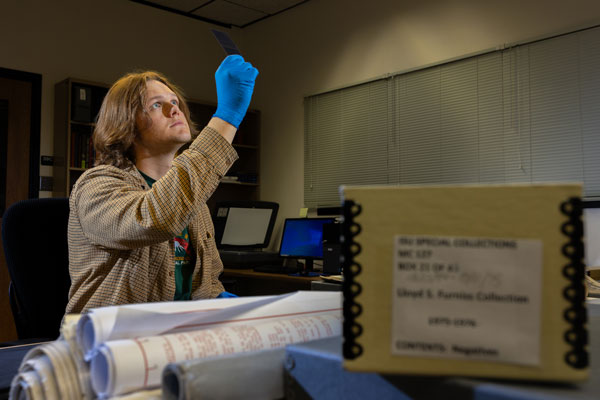 Brady Cooke, a Career Path Intern, views negatives