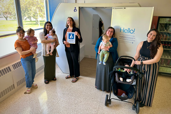 Mothers and babies in front of a new lactation pod at ISU